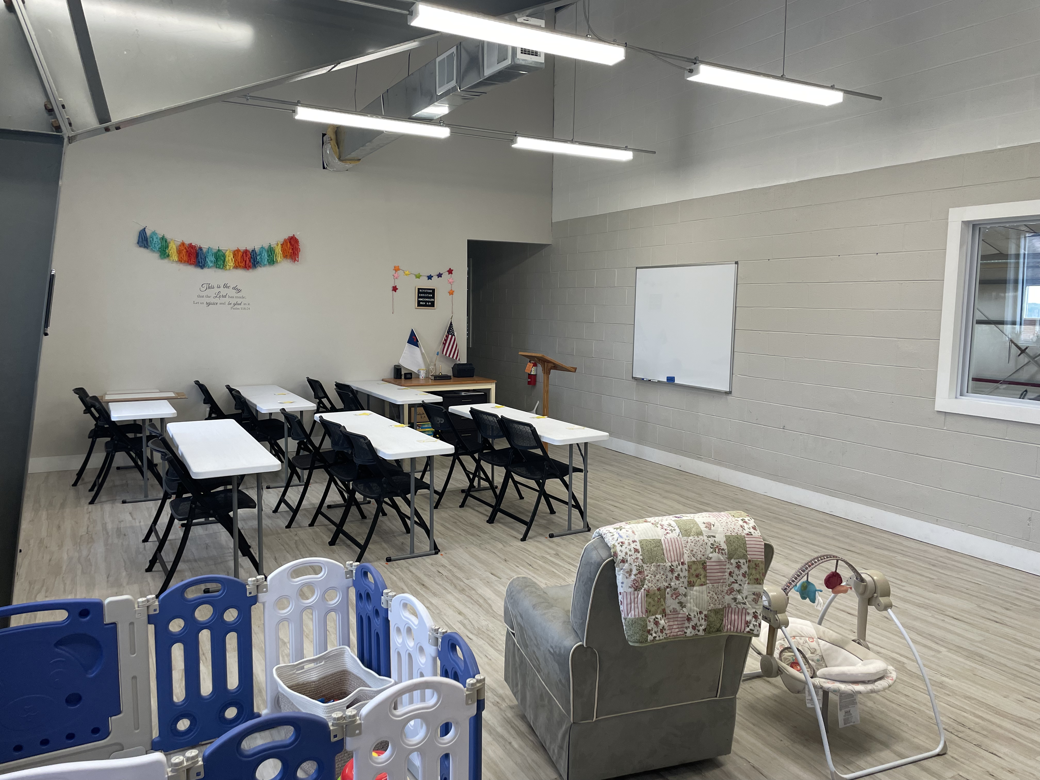 Our classroom at Keystone Baptist Church, with student tables and a play area for young children