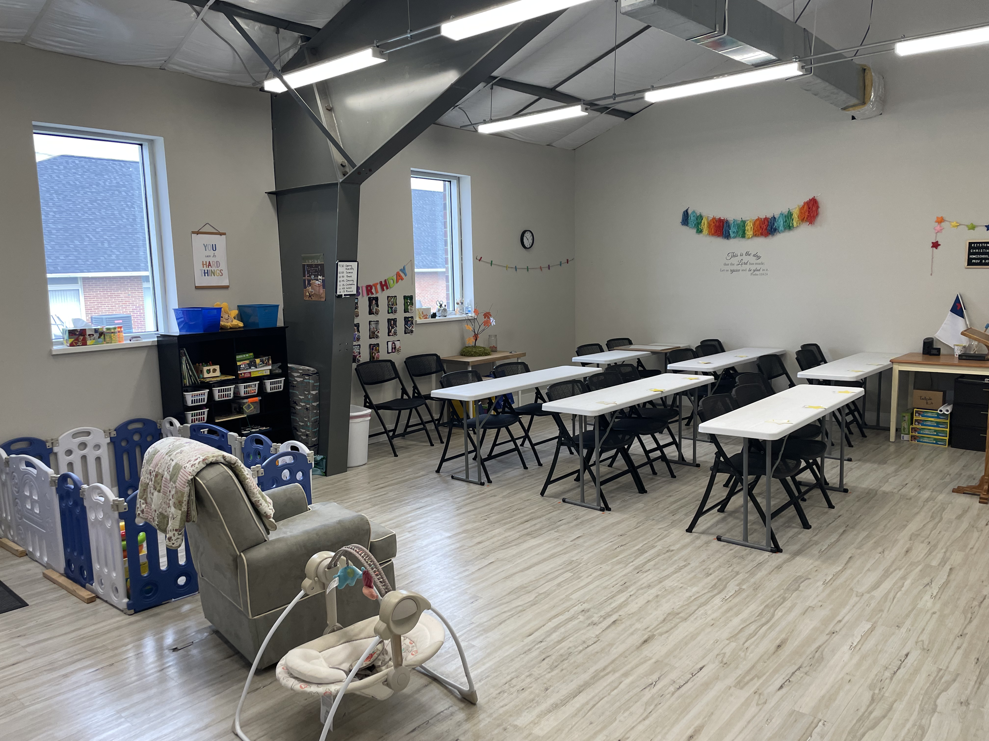 Another view of the classroom showing the bookshelves, windows and nursery corner